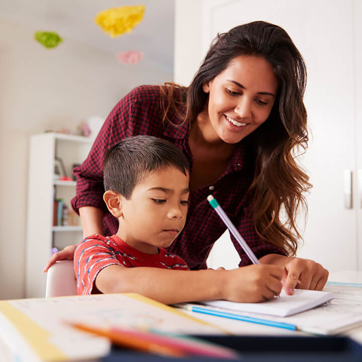 Parent and child working together at a table, representing stress-free homework time with Love and Logic strategies.