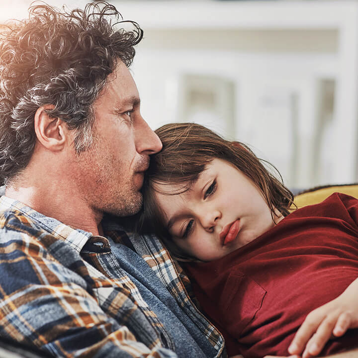 A parent sitting calmly with a child after a stressful moment, showing reassurance and emotional connection.