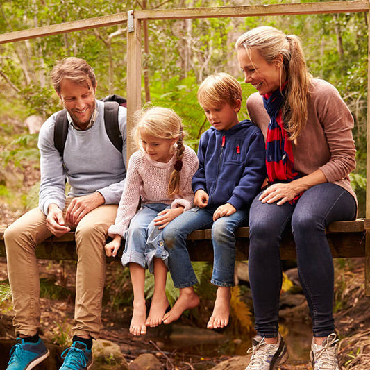 A family spending relaxed time together outdoors, reflecting healthy connection and supportive relationships.