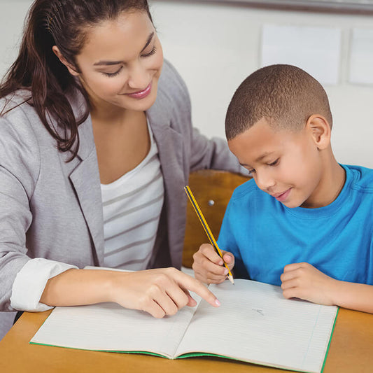 Teacher guiding a student with calm support, modeling the Love and Logic consultant approach in the classroom