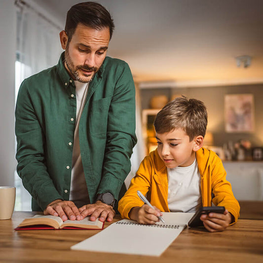 parent helping child develop responsibility and good study habits at home