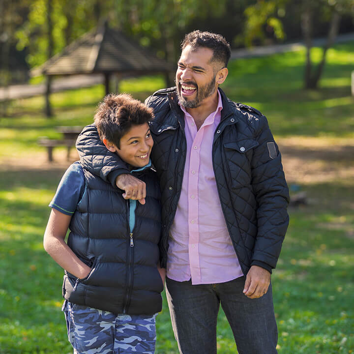 Stepparent and child walking together and smiling, reflecting connection, warmth, and the trust-building principles of the Love and Logic approach